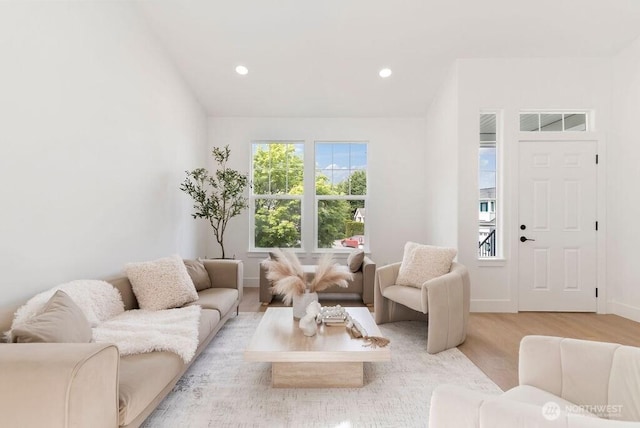 living area with light wood-style floors, recessed lighting, and baseboards
