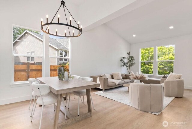 dining area featuring healthy amount of natural light, a chandelier, lofted ceiling, light wood-style flooring, and recessed lighting