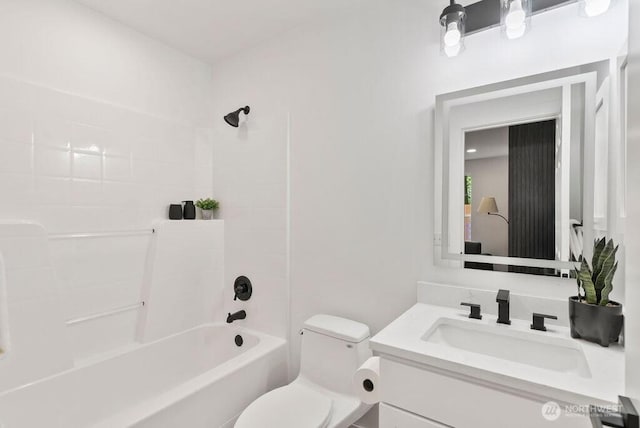 bathroom with vanity, toilet, and shower / tub combination