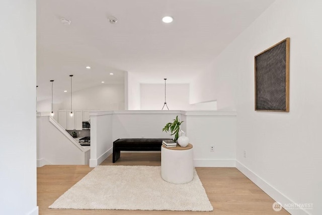 hall with light wood-style floors, recessed lighting, and baseboards