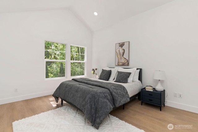bedroom featuring baseboards, wood finished floors, recessed lighting, and high vaulted ceiling