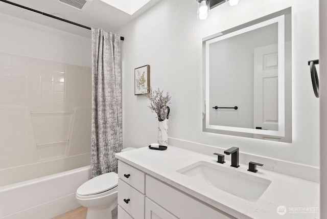bathroom featuring toilet, vanity, and shower / tub combo with curtain
