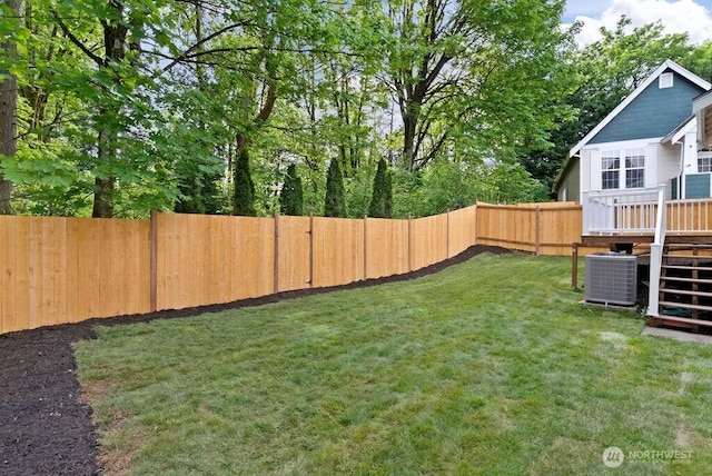 view of yard featuring central AC and a deck