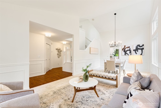 28132 24th Pl S, Federal Way, WA 98003 - living room featuring a decorative wall, a chandelier, wood finished floors, high vaulted ceiling, and a wainscoted wall
