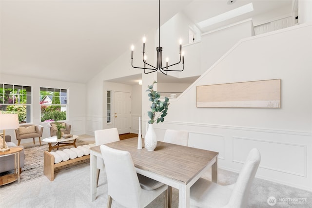 28132 24th Pl S, Federal Way, WA 98003 - dining space featuring a decorative wall, a chandelier, a wainscoted wall, light colored carpet, and vaulted ceiling
