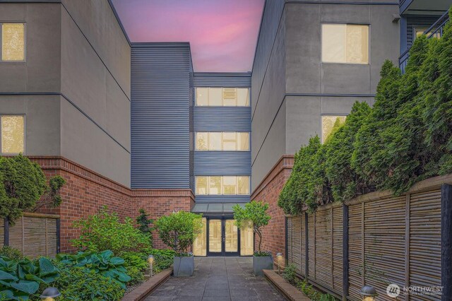 view of front of property featuring french doors and brick siding