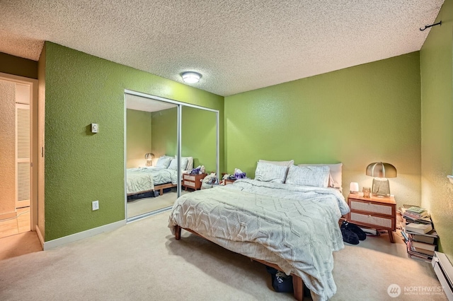 bedroom with a textured wall, carpet, a closet, a textured ceiling, and a baseboard radiator