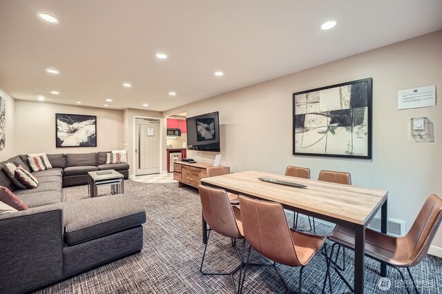 dining area featuring recessed lighting and carpet
