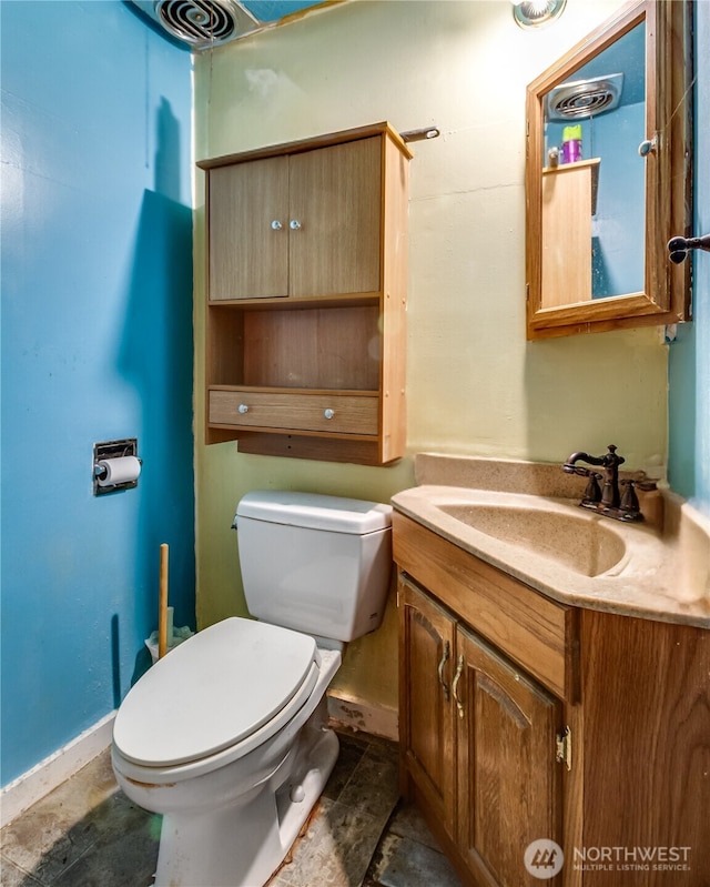 bathroom featuring toilet and vanity