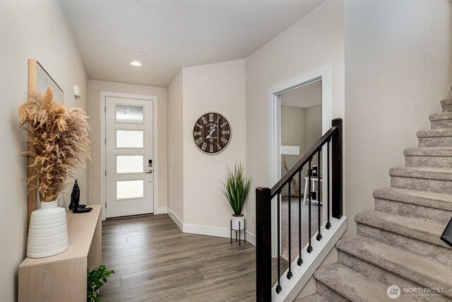 entrance foyer with stairway, wood finished floors, baseboards, and recessed lighting