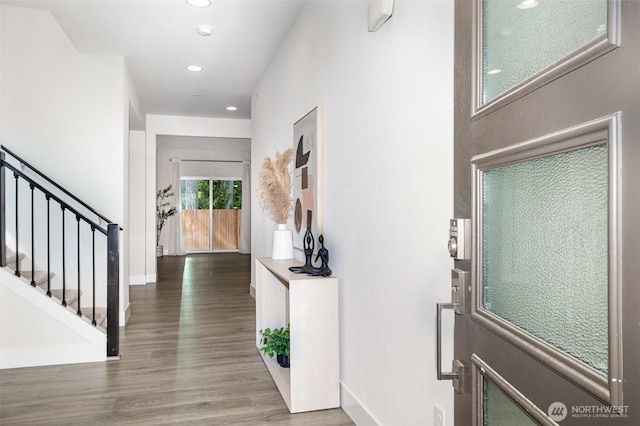 foyer with recessed lighting, wood finished floors, stairway, and baseboards