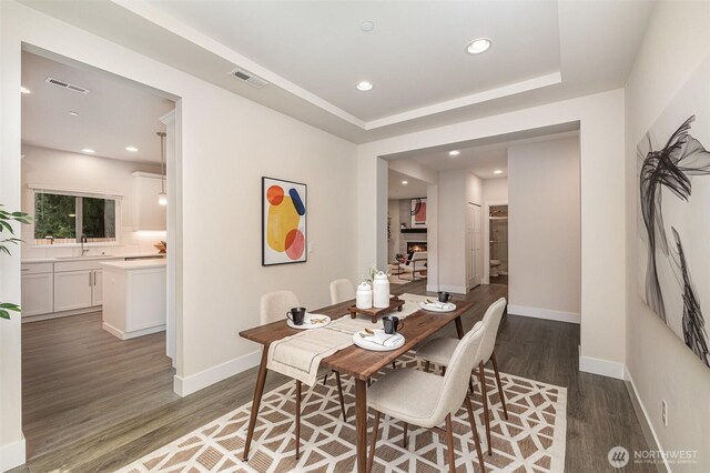 dining room featuring wood finished floors, recessed lighting, and baseboards