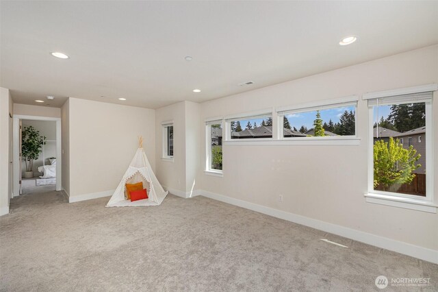 recreation room featuring carpet, plenty of natural light, recessed lighting, and baseboards