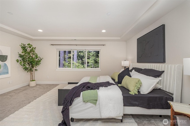 bedroom with carpet, a raised ceiling, recessed lighting, and baseboards