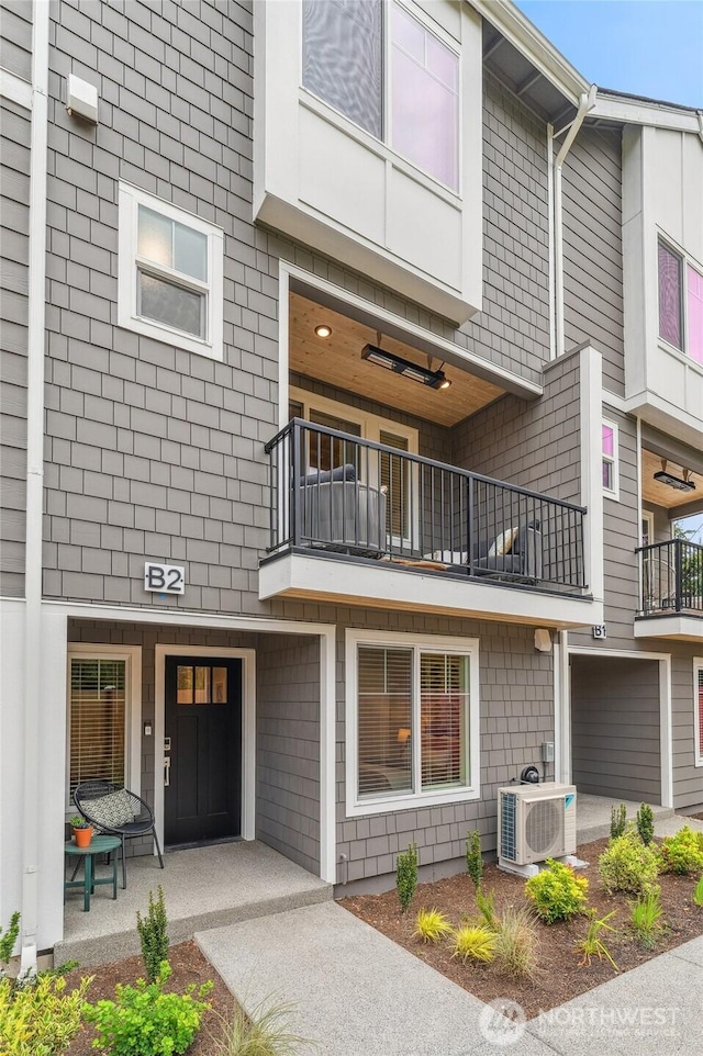 view of front facade with ac unit and a balcony
