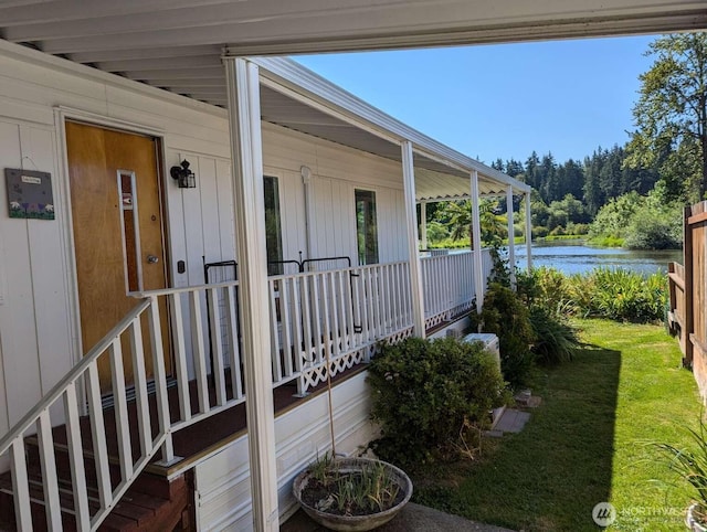 doorway to property with a water view and covered porch