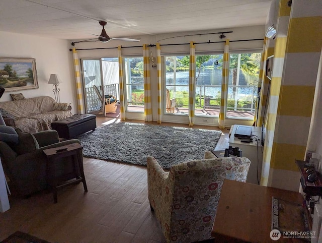 living area featuring hardwood / wood-style floors, plenty of natural light, and ceiling fan
