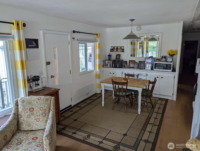 dining room featuring healthy amount of natural light and light wood-type flooring