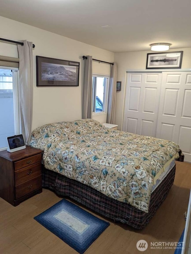 bedroom featuring wood finished floors and a closet