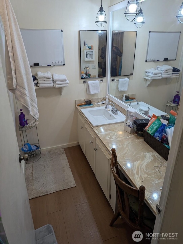 7301 NE 175th St Unit 140, Kenmore, WA 98028 - bathroom featuring wood finished floors, vanity, and baseboards