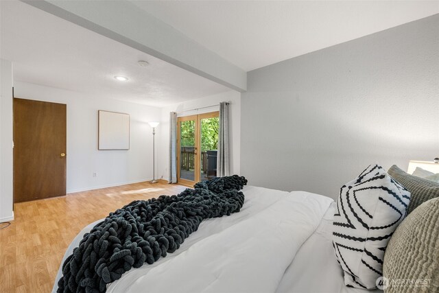 bedroom featuring access to exterior, light wood-type flooring, and baseboards