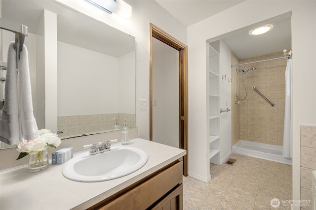 bathroom with vanity, a shower stall, and tile patterned floors