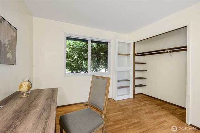 interior space with wood finished floors and baseboards