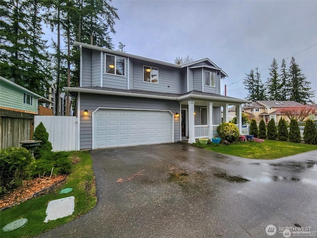 2332 130th Pl SE, Everett, WA 98208 - traditional-style house featuring an attached garage, fence, covered porch, and driveway