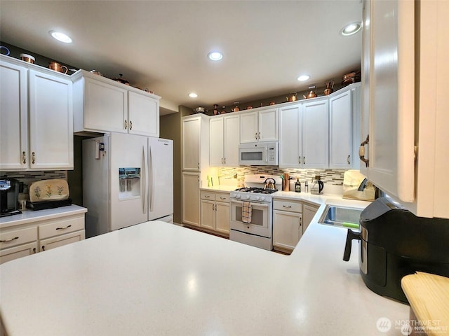 2332 130th Pl SE, Everett, WA 98208 - kitchen with white appliances, backsplash, light countertops, recessed lighting, and white cabinetry
