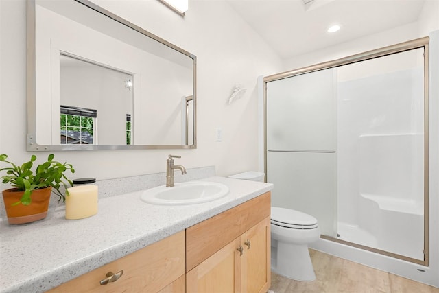 132 Sudden Valley Dr, Bellingham, WA 98229 - bathroom with a shower stall, vanity, toilet, wood finished floors, and recessed lighting