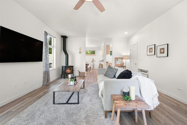 132 Sudden Valley Dr, Bellingham, WA 98229 - living room featuring wood finished floors, a wood stove, ceiling fan, baseboards, and recessed lighting