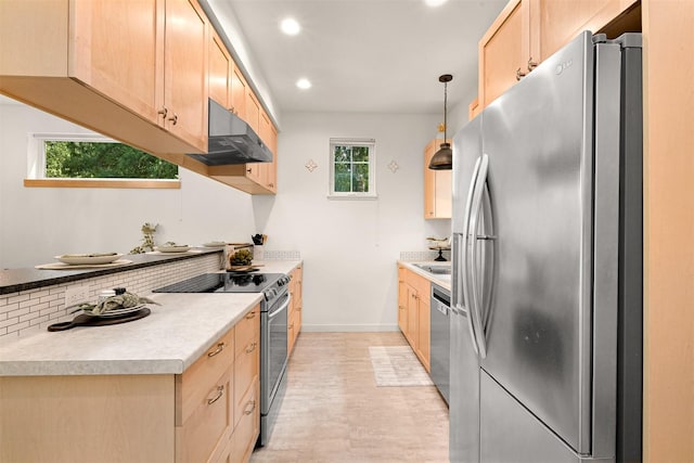 132 Sudden Valley Dr, Bellingham, WA 98229 - kitchen featuring appliances with stainless steel finishes, under cabinet range hood, light brown cabinets, baseboards, and recessed lighting