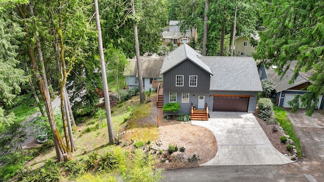 132 Sudden Valley Dr, Bellingham, WA 98229 - rustic home featuring a shingled roof, concrete driveway, and an attached garage
