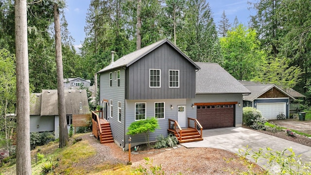132 Sudden Valley Dr, Bellingham, WA 98229 - view of front of house with driveway, a garage, board and batten siding, and a shingled roof