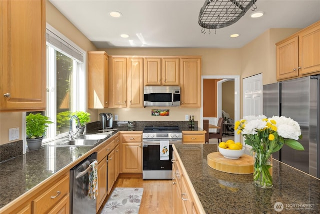 9437 NE Coral Ct, Bainbridge Island, WA 98110 - kitchen featuring stainless steel appliances, a sink, tile counters, light wood-type flooring, and recessed lighting