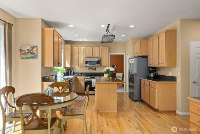 9437 NE Coral Ct, Bainbridge Island, WA 98110 - kitchen with appliances with stainless steel finishes, light brown cabinetry, light wood-style floors, a center island, and recessed lighting