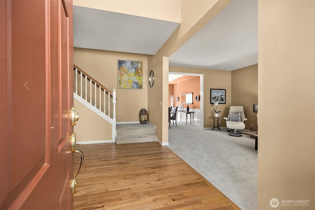 9437 NE Coral Ct, Bainbridge Island, WA 98110 - foyer with stairway, wood finished floors, and baseboards