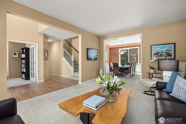 9437 NE Coral Ct, Bainbridge Island, WA 98110 - living area featuring carpet flooring, stairs, baseboards, and a chandelier
