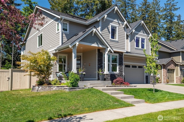 4213 Caddyshack Dr NE, Lacey, WA 98516 - craftsman-style home with an attached garage, stone siding, covered porch, driveway, and roof with shingles