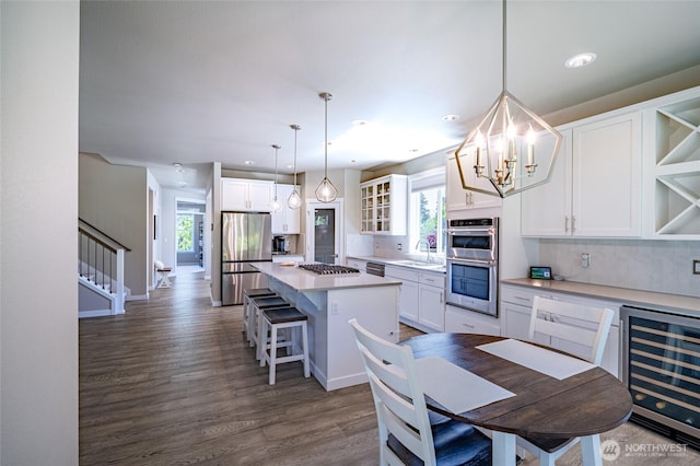 4213 Caddyshack Dr NE, Lacey, WA 98516 - dining space featuring wine cooler, a chandelier, dark wood-style floors, recessed lighting, and stairway