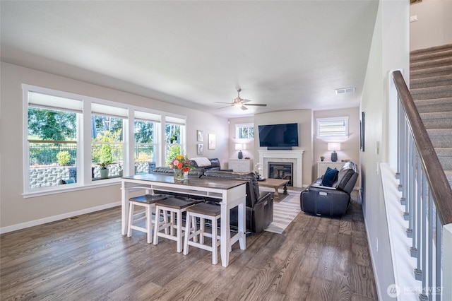 4213 Caddyshack Dr NE, Lacey, WA 98516 - living room with wood finished floors, stairway, a ceiling fan, a glass covered fireplace, and baseboards