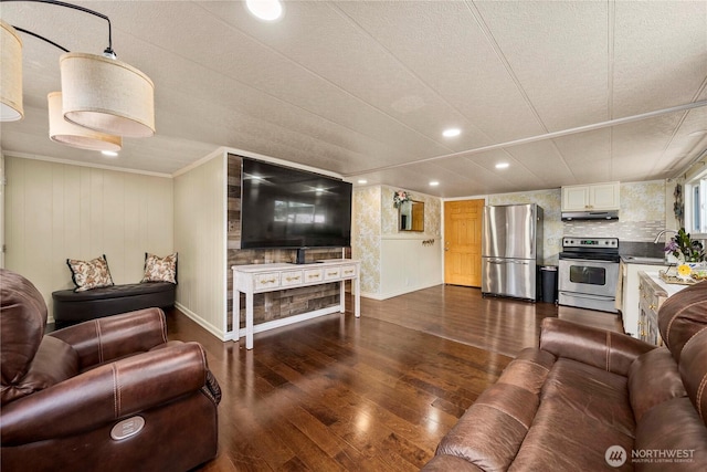 1921 208th St E Unit 9, Spanaway, WA 98387 - living area with dark wood finished floors, recessed lighting, baseboards, and crown molding