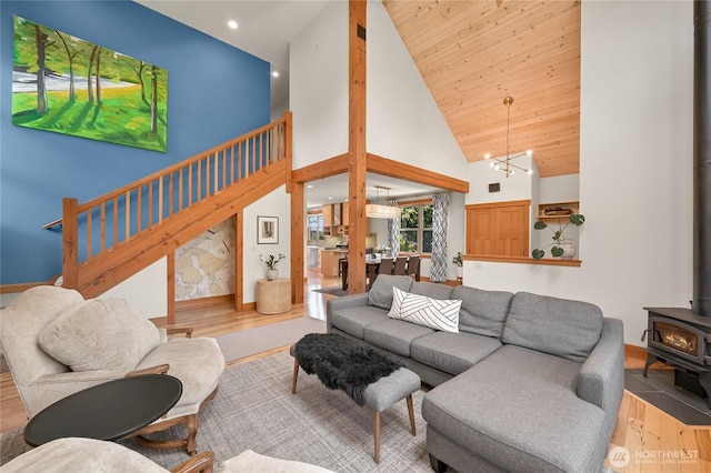 2518 S Park Dr, Bellingham, WA 98225 - living area with a wood stove, wood finished floors, high vaulted ceiling, stairs, and recessed lighting