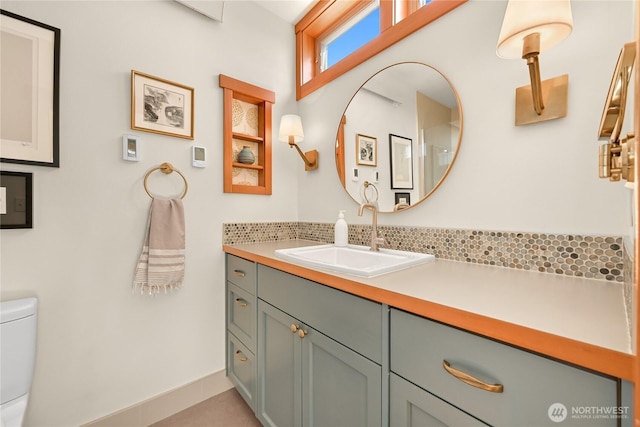 2518 S Park Dr, Bellingham, WA 98225 - bathroom featuring toilet, vanity, baseboards, and tasteful backsplash