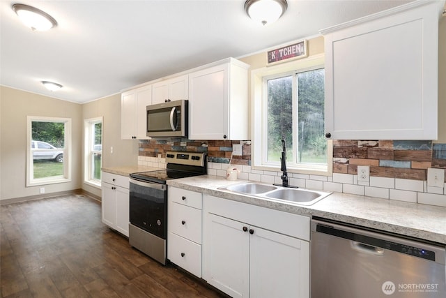 486 Justus Rd, Cinebar, WA 98533 - kitchen with appliances with stainless steel finishes, a sink, backsplash, and dark wood-type flooring