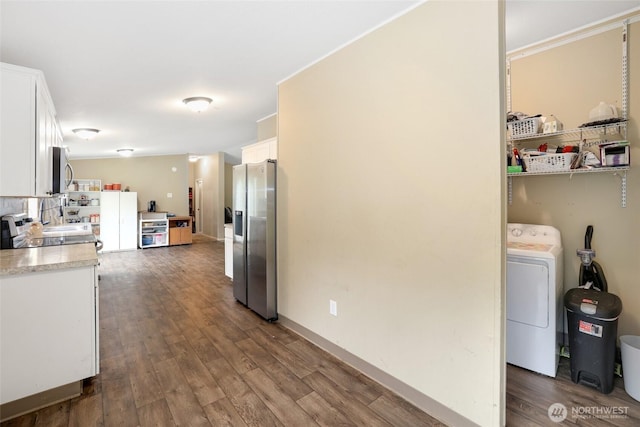 486 Justus Rd, Cinebar, WA 98533 - kitchen featuring appliances with stainless steel finishes, washer / dryer, white cabinetry, dark wood-type flooring, and light countertops