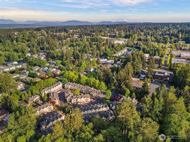aerial overview of property's location featuring mountains and a heavily wooded area