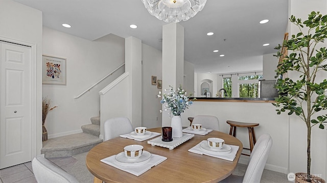 tiled dining space featuring stairs, recessed lighting, and baseboards