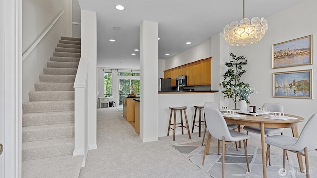 dining room featuring light carpet, stairway, recessed lighting, and baseboards