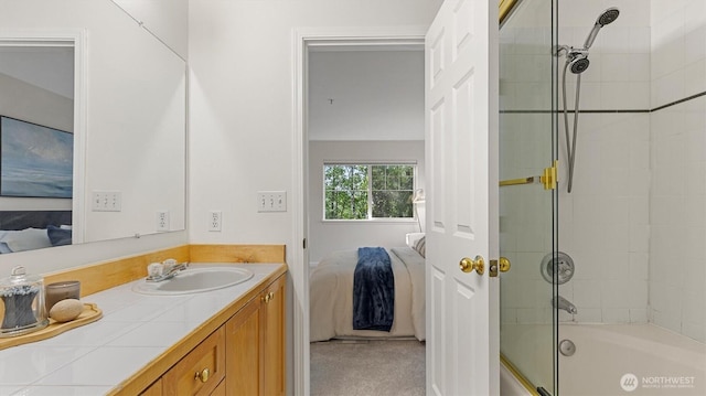ensuite bathroom with vanity and enclosed tub / shower combo